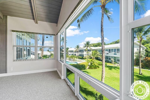 320 S Ocean Blvd Unit U-C, Delray Beach, FL 33483 - unfurnished sunroom with baseboards, carpet, wood ceiling, and beamed ceiling