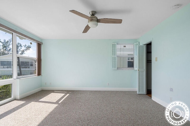 carpeted empty room with ceiling fan