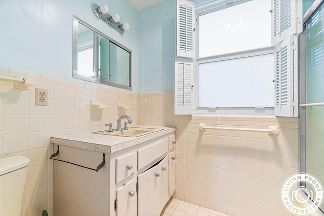 320 S Ocean Blvd Unit U-C, Delray Beach, FL 33483 - bathroom featuring tile walls, toilet, vanity, and wainscoting
