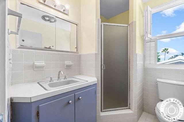 320 S Ocean Blvd Unit U-C, Delray Beach, FL 33483 - full bath with tile walls, a stall shower, vanity, toilet, and wainscoting