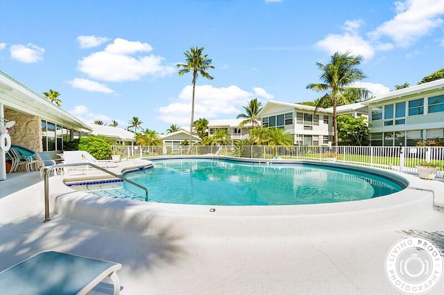 pool with fence and a patio