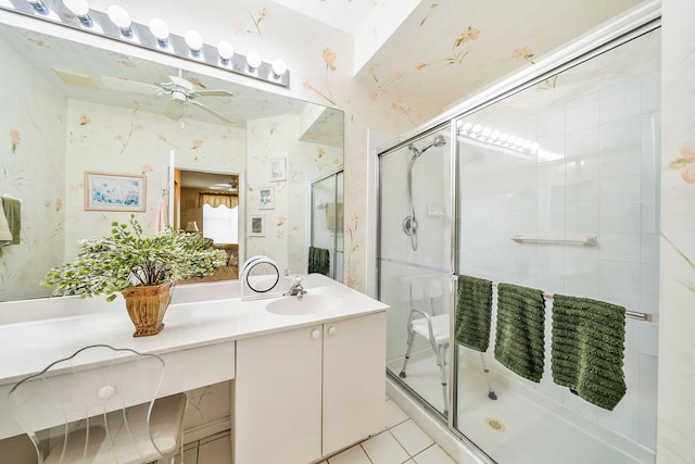 bathroom featuring a shower with shower door, vanity, tile patterned floors, and ceiling fan