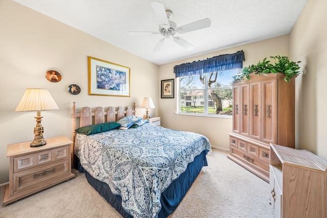 carpeted bedroom with a textured ceiling and ceiling fan