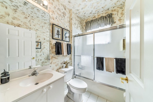 full bathroom with vanity, tile patterned flooring, bath / shower combo with glass door, and toilet