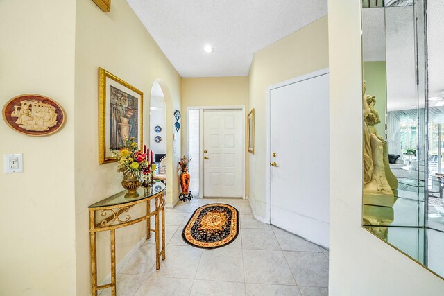 tiled foyer featuring a textured ceiling