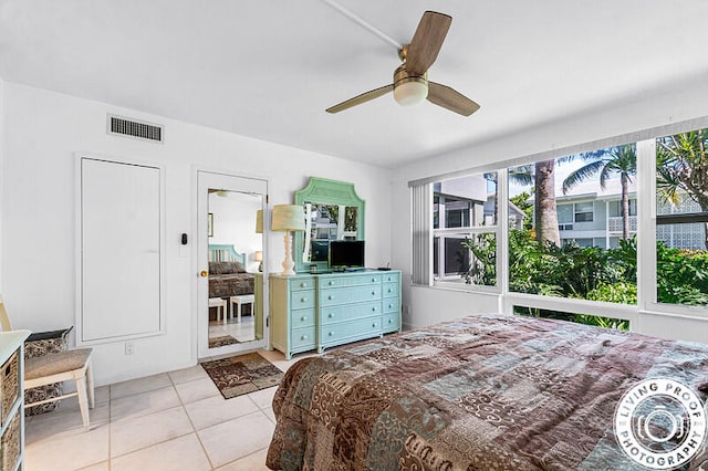 bedroom with ceiling fan and light tile patterned flooring