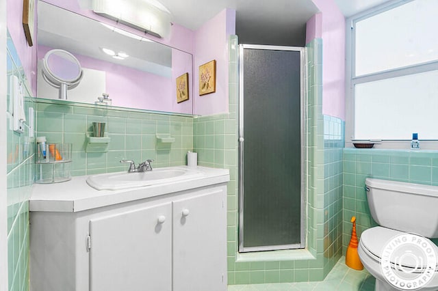 bathroom featuring a wealth of natural light, vanity, tile walls, and walk in shower