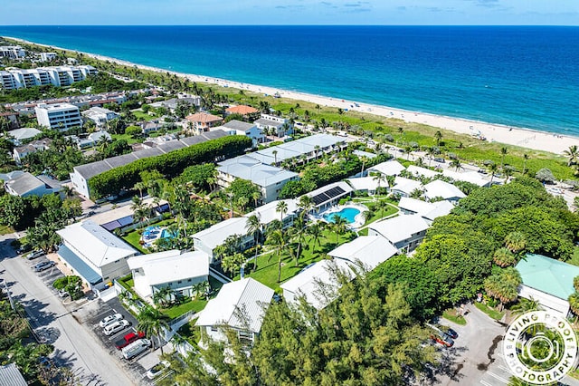 birds eye view of property featuring a beach view and a water view