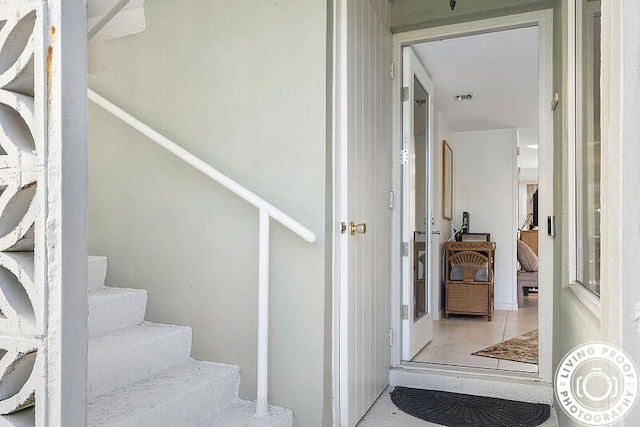 stairs featuring tile patterned flooring