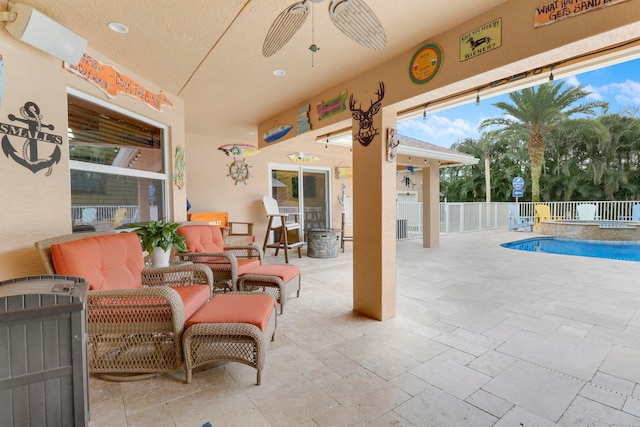 view of patio / terrace with ceiling fan and a fenced in pool