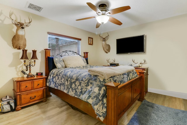 bedroom with light hardwood / wood-style flooring and ceiling fan