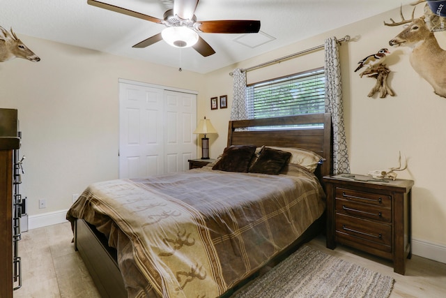 bedroom featuring hardwood / wood-style flooring, a closet, and ceiling fan