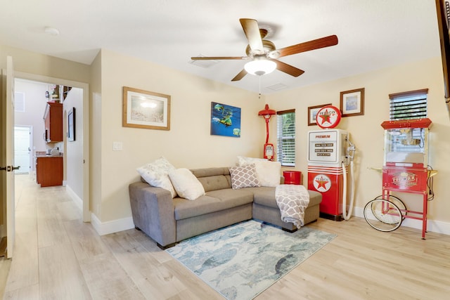 living room featuring ceiling fan and hardwood / wood-style flooring