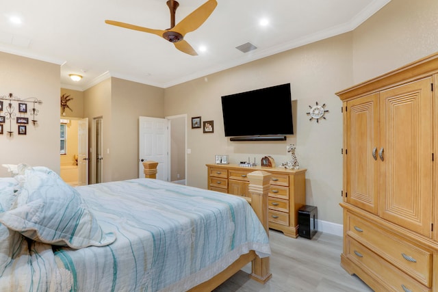 bedroom with crown molding, light wood-type flooring, ceiling fan, and connected bathroom