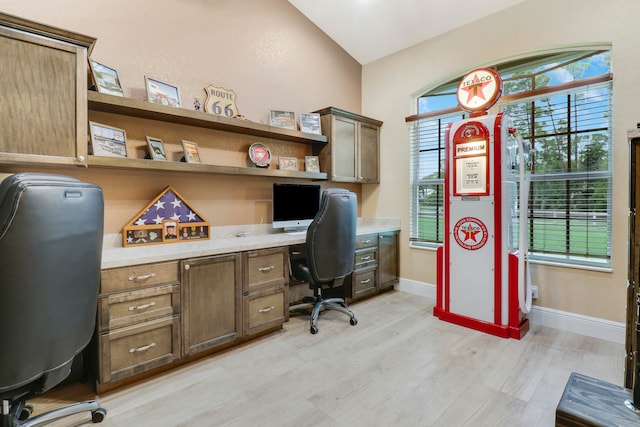 home office with built in desk, light wood-type flooring, and plenty of natural light