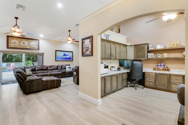 office space featuring built in desk, light hardwood / wood-style flooring, ornamental molding, and ceiling fan