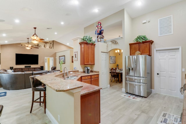 kitchen with sink, light wood-type flooring, ceiling fan, and stainless steel fridge with ice dispenser