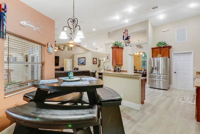 dining room with high vaulted ceiling, ceiling fan, and light hardwood / wood-style floors