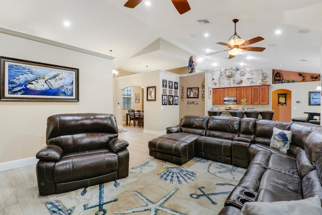 living room featuring lofted ceiling, light wood-type flooring, and ceiling fan