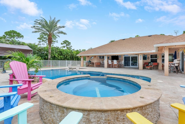 view of pool featuring an in ground hot tub and a patio