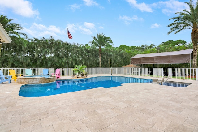 view of swimming pool with an in ground hot tub and a patio area