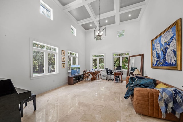 living room featuring a towering ceiling, ornamental molding, coffered ceiling, beam ceiling, and an inviting chandelier