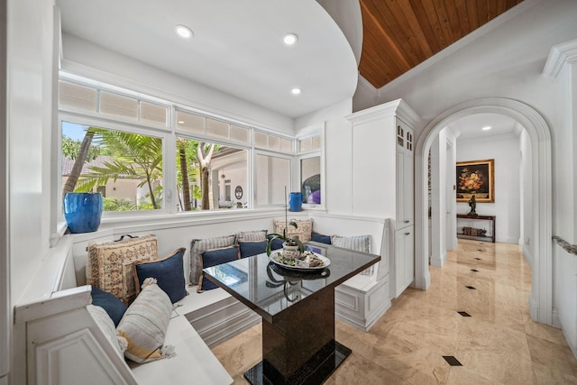 dining area featuring crown molding and wooden ceiling