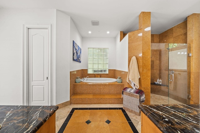 bathroom with tile patterned floors and shower with separate bathtub