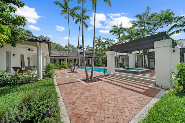 view of swimming pool with an in ground hot tub and a patio