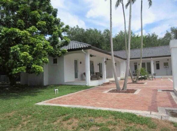 back of house with ceiling fan, a patio area, and a lawn