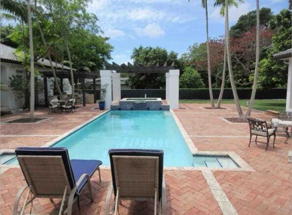 view of swimming pool with a patio area and an in ground hot tub