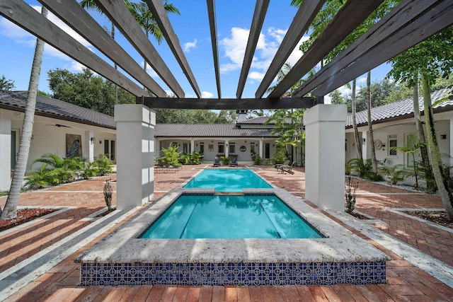 view of swimming pool with an in ground hot tub, a pergola, and a patio