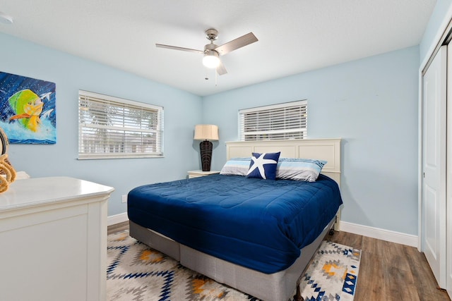 bedroom featuring ceiling fan, a closet, and wood-type flooring