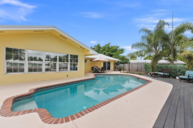 view of pool with a wooden deck