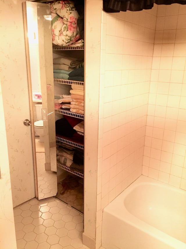 bathroom with tile patterned floors