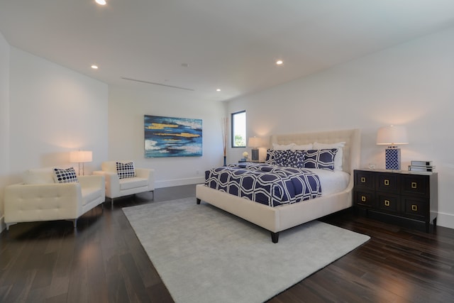 bedroom with dark hardwood / wood-style floors