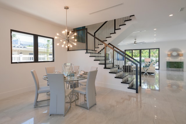 dining area featuring light tile patterned flooring and ceiling fan with notable chandelier