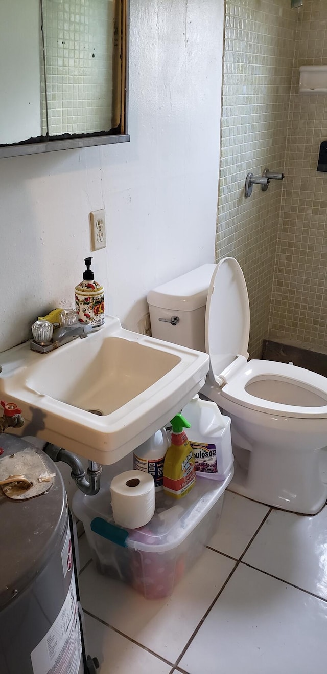 bathroom with toilet and tile patterned floors