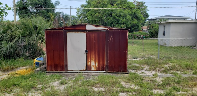 view of shed with fence