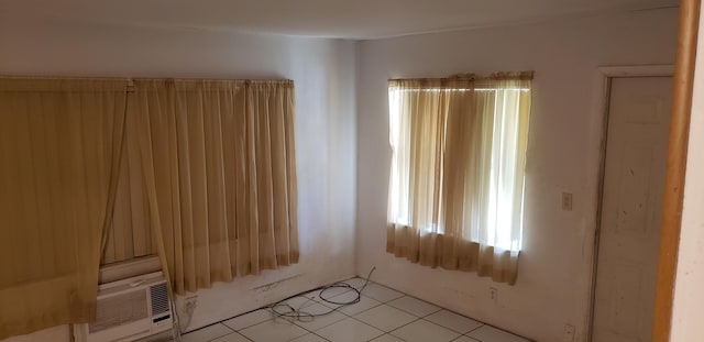 spare room with cooling unit and light tile patterned floors