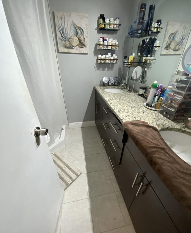 bathroom featuring double vanity and tile patterned flooring