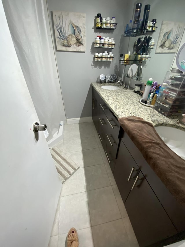 bathroom featuring tile patterned flooring and vanity