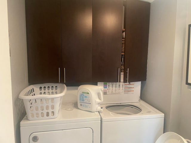 washroom featuring cabinets and independent washer and dryer