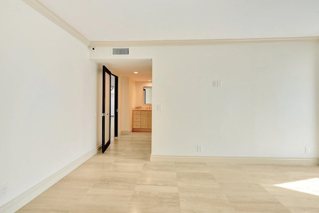 empty room featuring crown molding