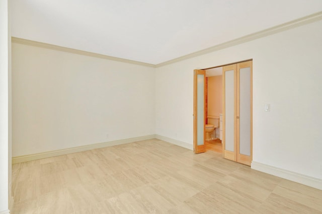 empty room featuring crown molding