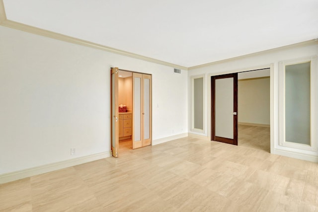 unfurnished bedroom with ornamental molding and a closet