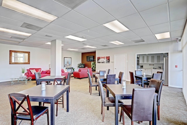 dining room with a drop ceiling and carpet floors