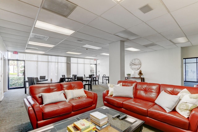 living room with carpet flooring and a drop ceiling