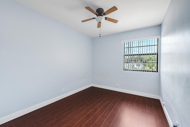 spare room with dark wood-type flooring and ceiling fan