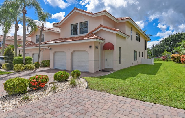 mediterranean / spanish-style house featuring a garage and a front lawn